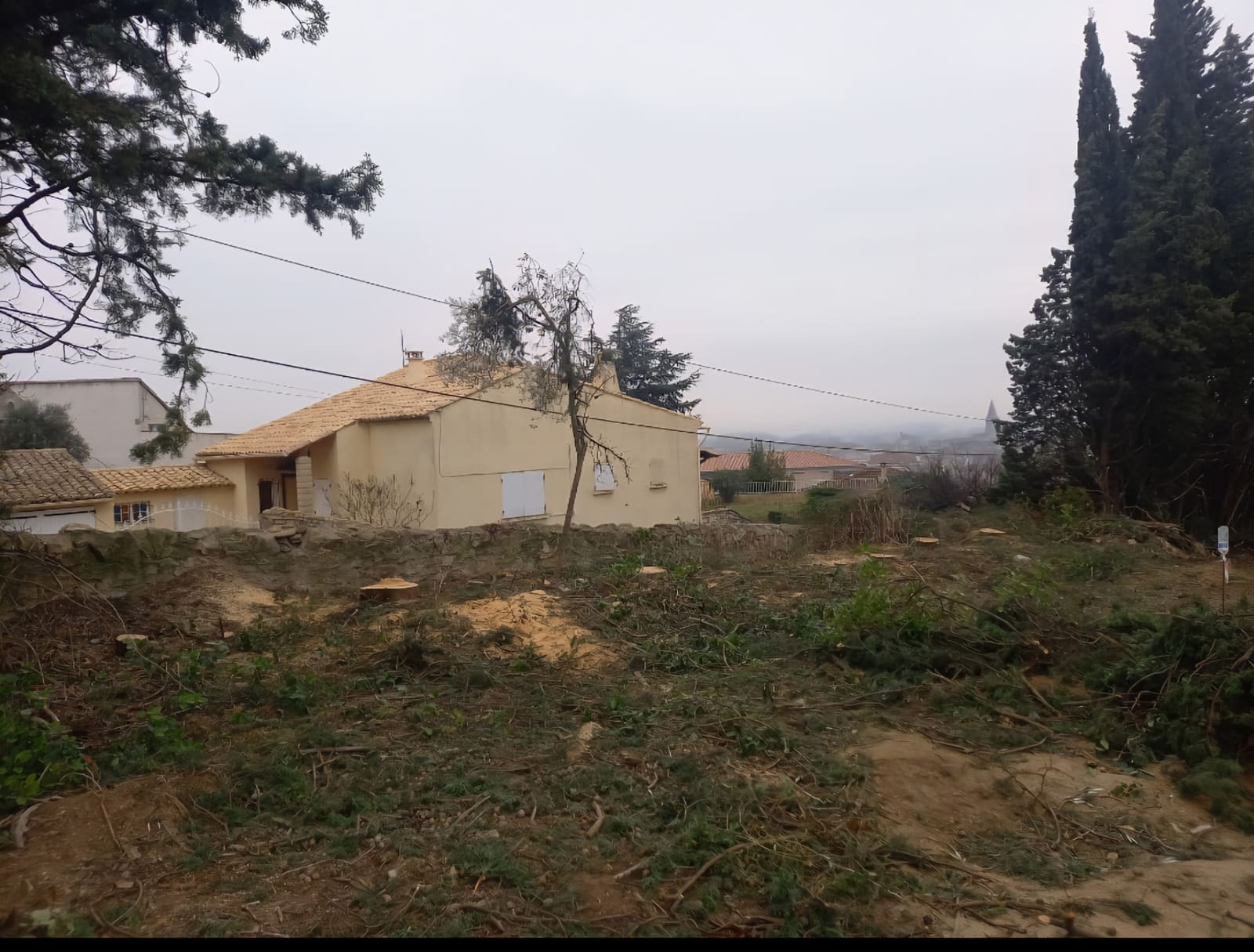 Terrain dégagé après débroussaillage, abords de maison nettoyés